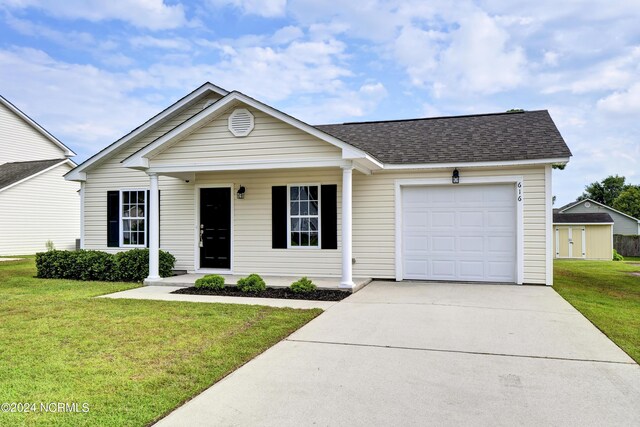 ranch-style house featuring a garage and a front lawn