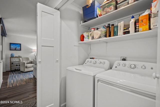 laundry room featuring washer and dryer, ornamental molding, and hardwood / wood-style floors