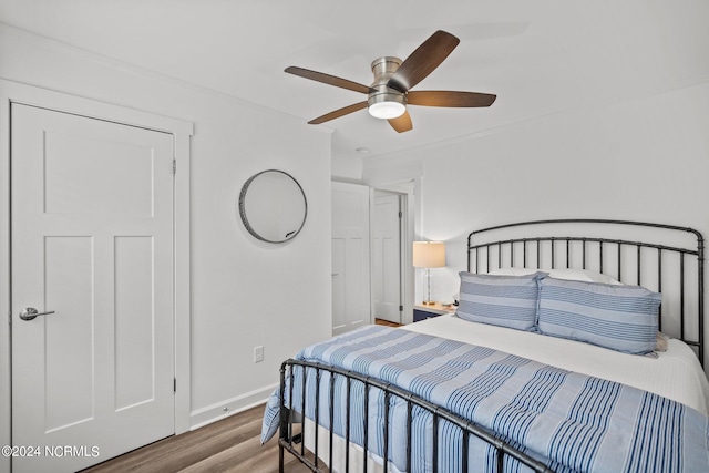 bedroom with hardwood / wood-style floors and ceiling fan