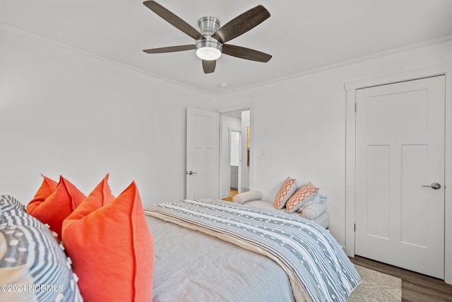 bedroom with ceiling fan, wood-type flooring, and ornamental molding