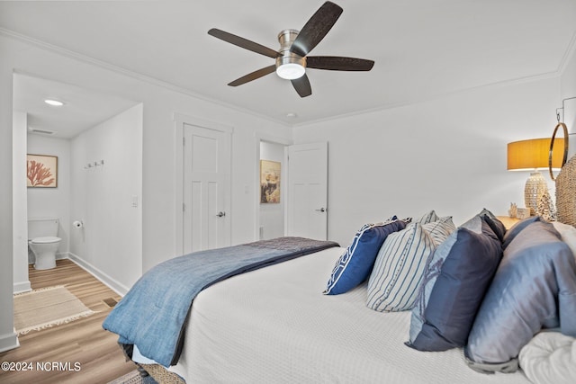 bedroom featuring ensuite bath, light hardwood / wood-style flooring, ornamental molding, and ceiling fan