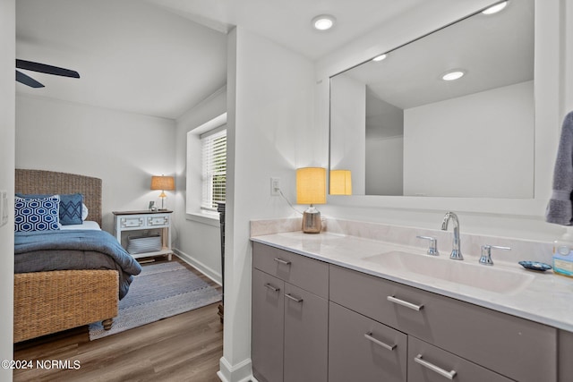 bathroom featuring ceiling fan, vanity, and hardwood / wood-style flooring