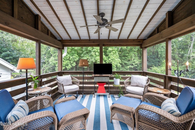 sunroom featuring ceiling fan, wooden ceiling, and lofted ceiling with beams