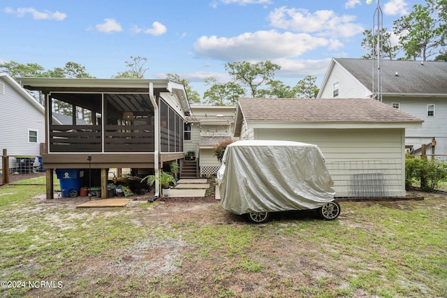 rear view of property with a sunroom