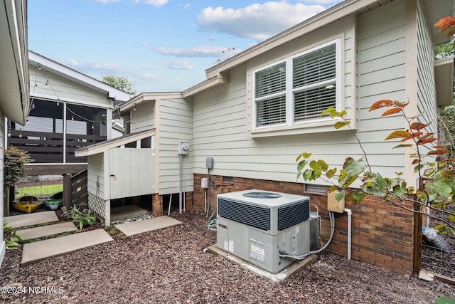 back of property with central air condition unit and a deck