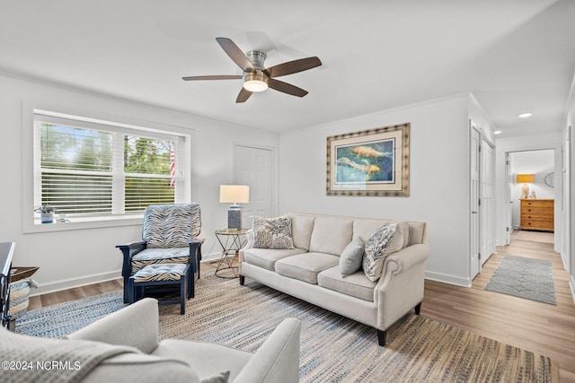 living room with light hardwood / wood-style flooring and ceiling fan