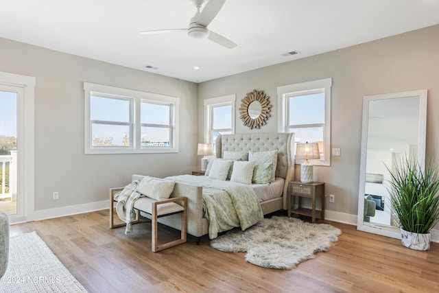 bedroom featuring multiple windows, light wood-type flooring, and ceiling fan