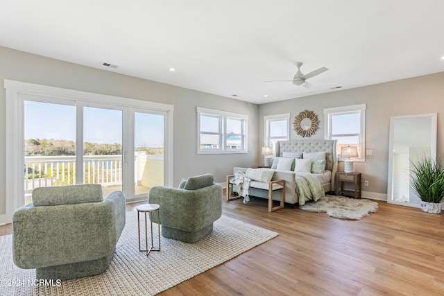 bedroom featuring access to exterior, light wood-type flooring, and ceiling fan