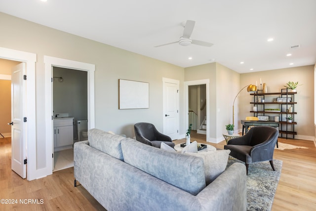 living room featuring light wood-type flooring and ceiling fan