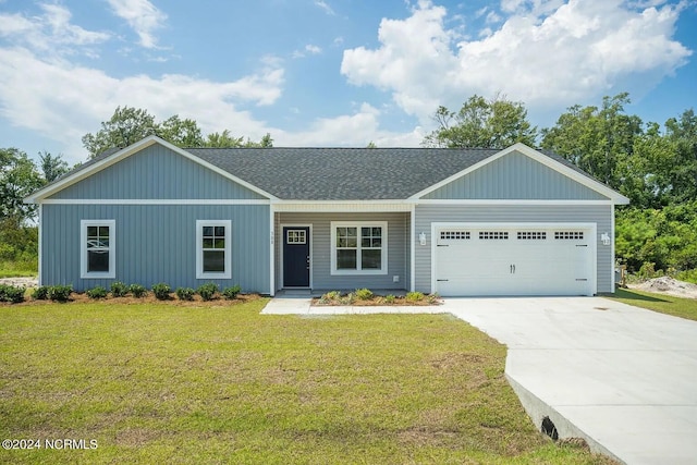 ranch-style house featuring a front yard and a garage