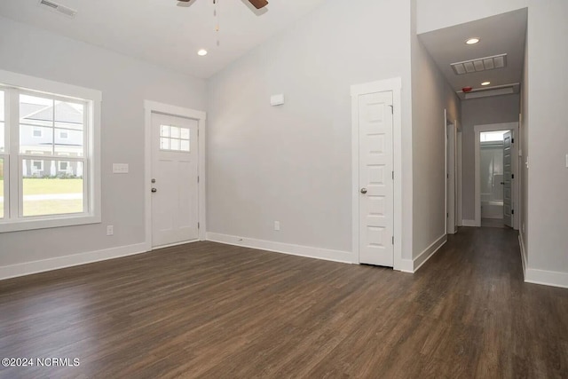 foyer entrance with ceiling fan, dark hardwood / wood-style floors, and high vaulted ceiling