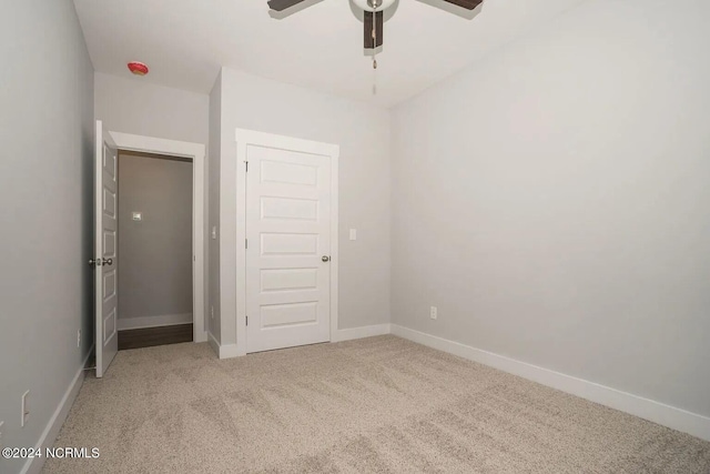 unfurnished bedroom featuring carpet flooring, a closet, and ceiling fan