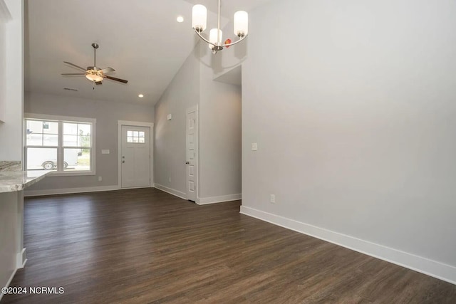 foyer entrance with ceiling fan with notable chandelier, dark hardwood / wood-style flooring, and high vaulted ceiling