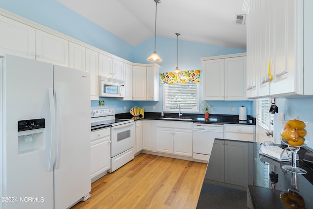 kitchen featuring dark countertops, white appliances, white cabinetry, and a sink