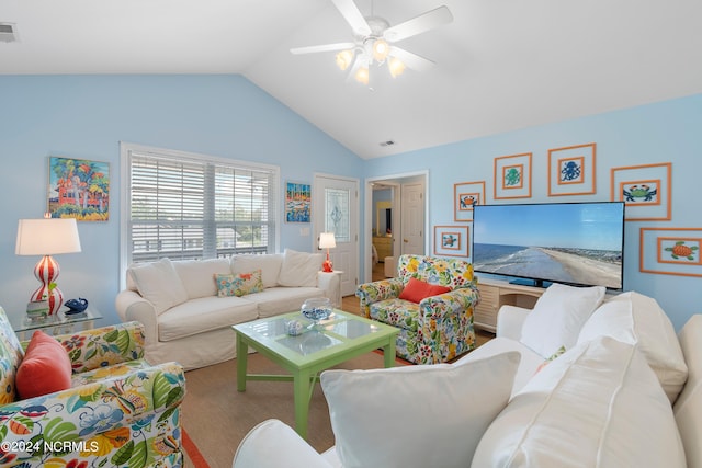 living area featuring lofted ceiling, visible vents, and ceiling fan