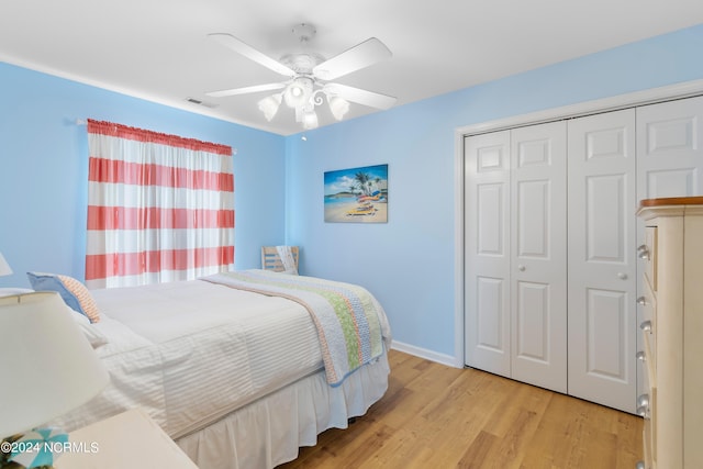 bedroom featuring a closet, light hardwood / wood-style floors, and ceiling fan