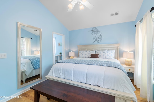 bedroom featuring light hardwood / wood-style floors, vaulted ceiling, and ceiling fan