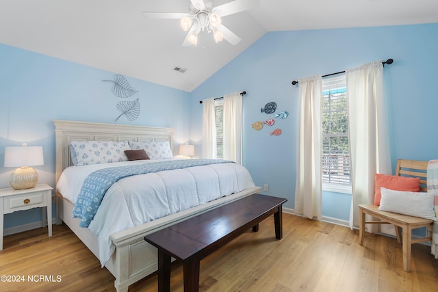 bedroom with vaulted ceiling, light hardwood / wood-style flooring, multiple windows, and ceiling fan