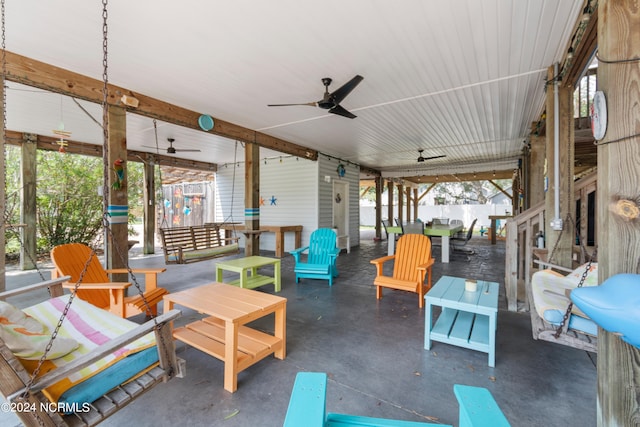 view of patio featuring outdoor dining space, ceiling fan, and fence