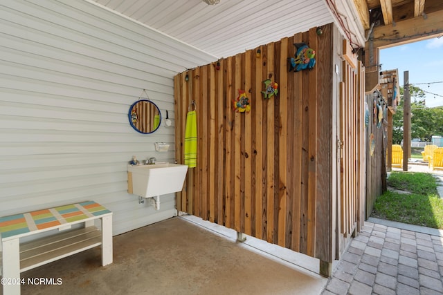 exterior space with wooden walls and a sink