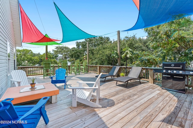 wooden deck featuring area for grilling