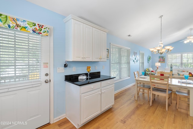 kitchen featuring dark countertops, light wood-style floors, visible vents, and white cabinets