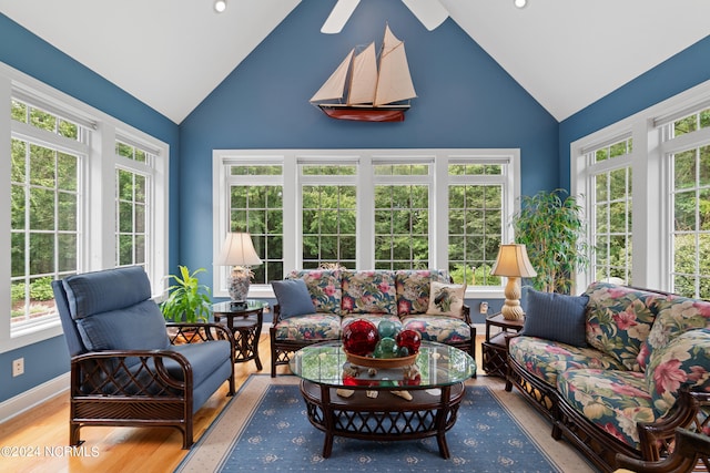 sunroom / solarium featuring vaulted ceiling and plenty of natural light