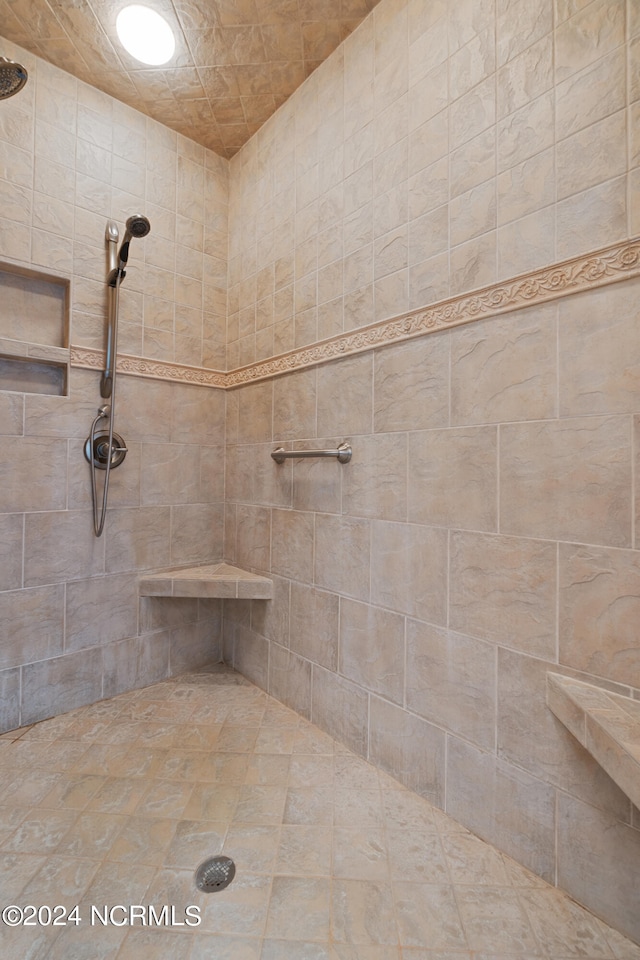 bathroom with a tile shower