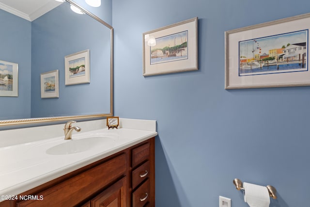 bathroom with ornamental molding and vanity