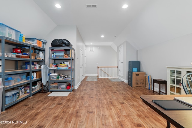 interior space featuring lofted ceiling and light hardwood / wood-style flooring