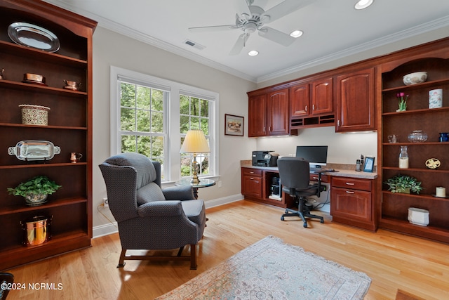 office space with ornamental molding, visible vents, light wood finished floors, and a ceiling fan