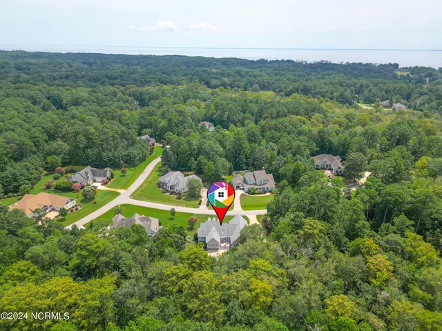 drone / aerial view featuring a forest view