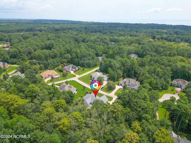 birds eye view of property featuring a residential view and a view of trees