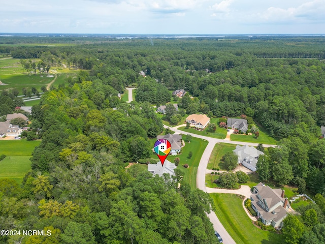 birds eye view of property featuring a wooded view