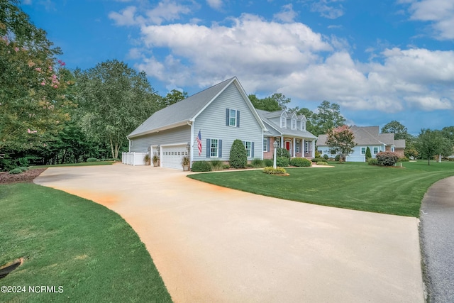 view of front of property featuring concrete driveway, an attached garage, and a front lawn