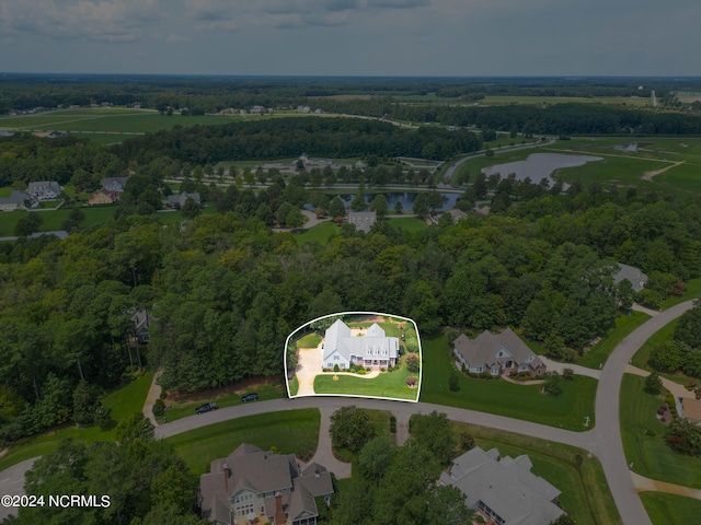 birds eye view of property with a water view and a forest view