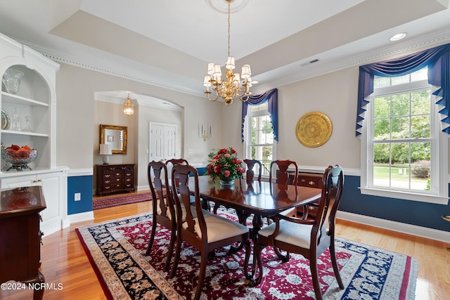 dining space featuring crown molding, plenty of natural light, and light hardwood / wood-style flooring