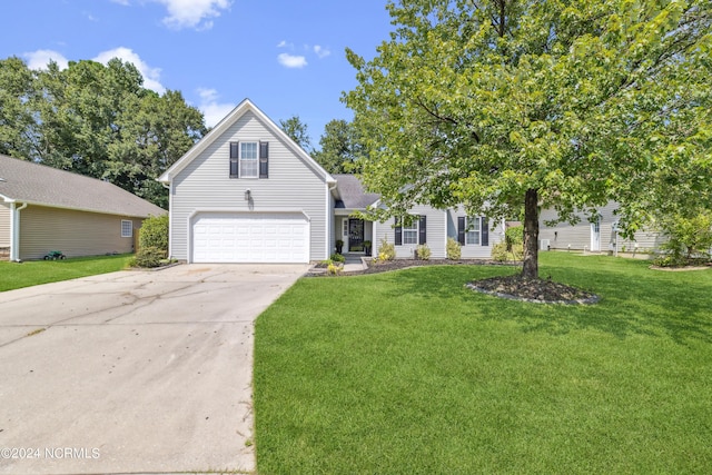 view of front facade featuring a garage, driveway, and a front lawn