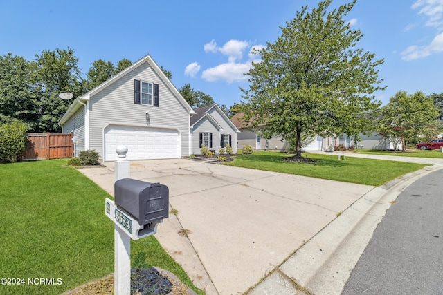 traditional-style home with driveway, a front lawn, and fence