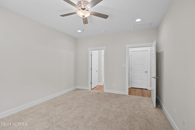 unfurnished bedroom with ceiling fan and light colored carpet