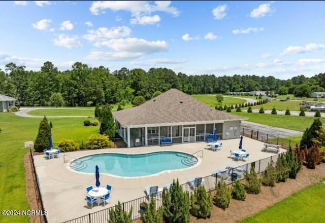 view of swimming pool featuring a lawn and a patio area