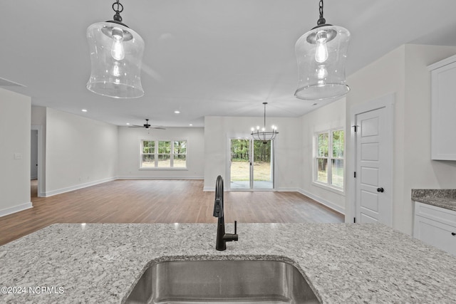 kitchen with white cabinets, sink, and light hardwood / wood-style floors