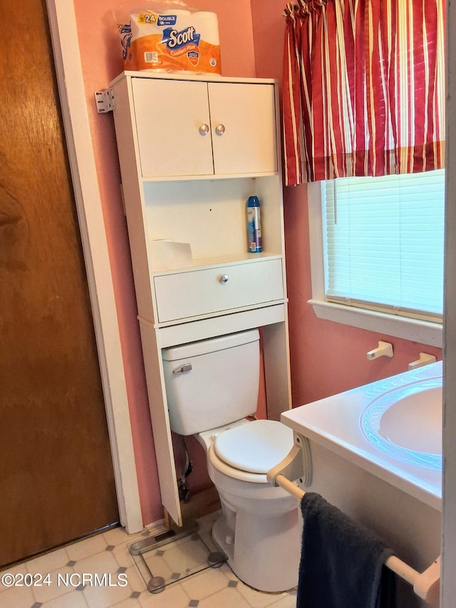 bathroom with vanity, toilet, and tile patterned floors