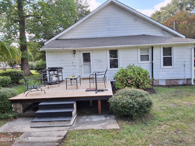 rear view of property with crawl space, roof with shingles, and a wooden deck