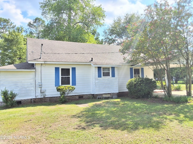 ranch-style home featuring crawl space, roof with shingles, and a front yard