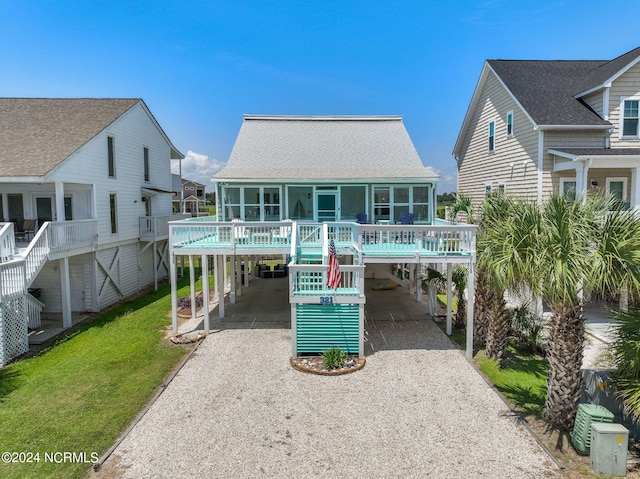 back of house with a carport