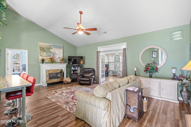 living room with ceiling fan, high vaulted ceiling, and wood-type flooring