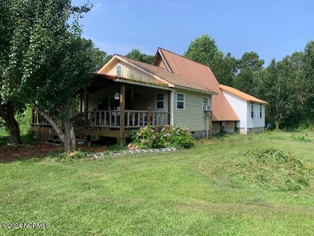 back of property featuring a lawn