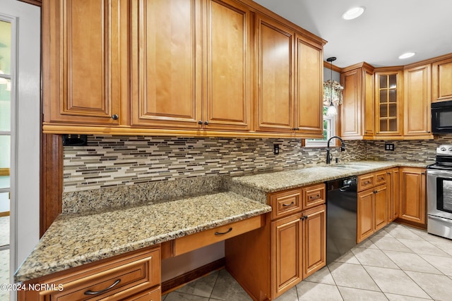 kitchen featuring sink, light stone countertops, black appliances, and backsplash