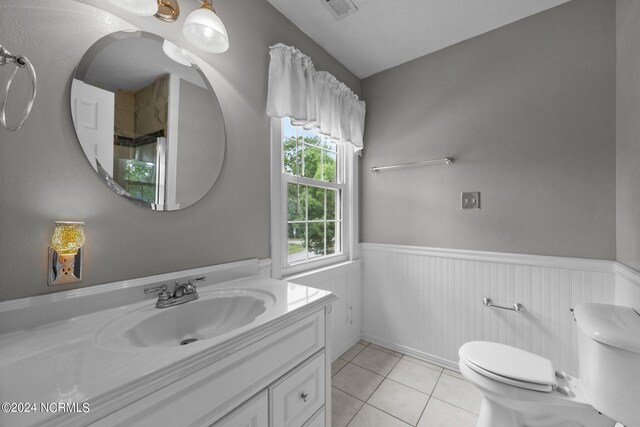 bathroom featuring tile patterned floors, vanity, and toilet